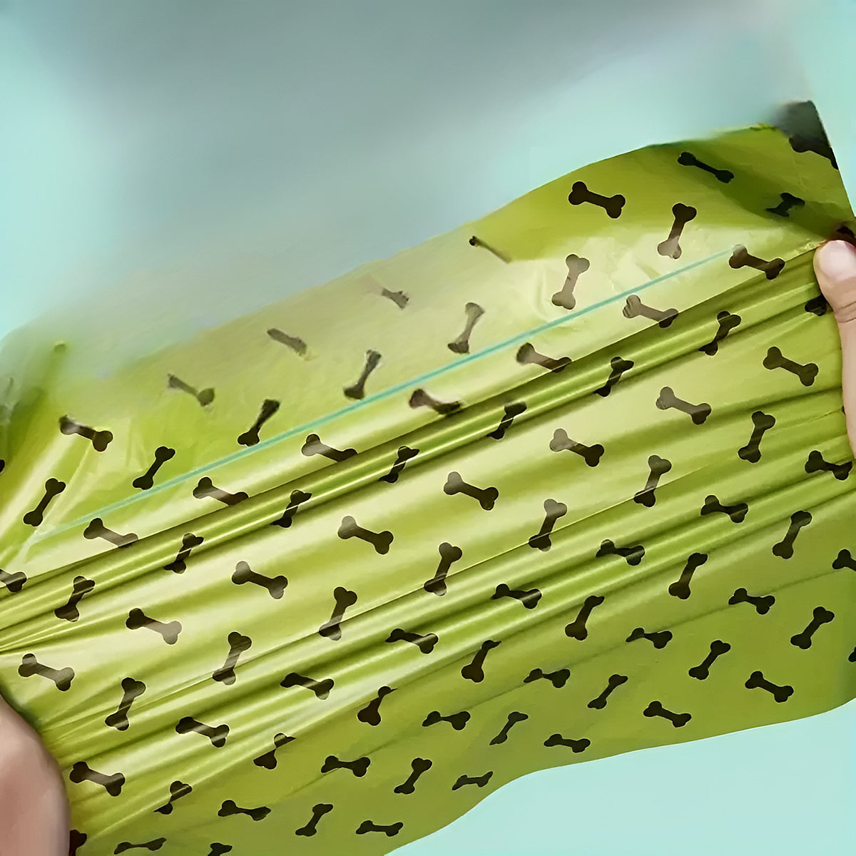 Sac à crottes vert étiré, à motif os